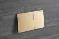 2023 Sigma70 square stainless steel brass on concrete wall.tif_geberit_dam-media-large(1).jpg